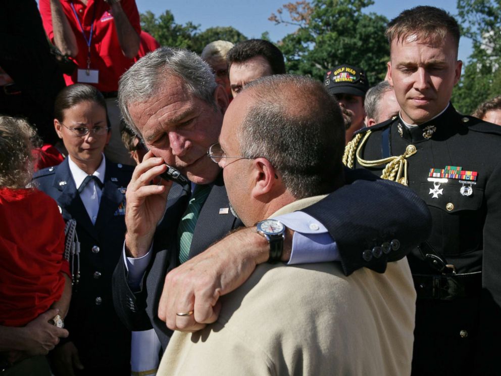 PHOTO: President George W. Bush stands with his arm around Jeff Hallal while speaking on the phone to his wife, Pam Hallal, Sept. 18, 2007 on the South Lawn of the White House.