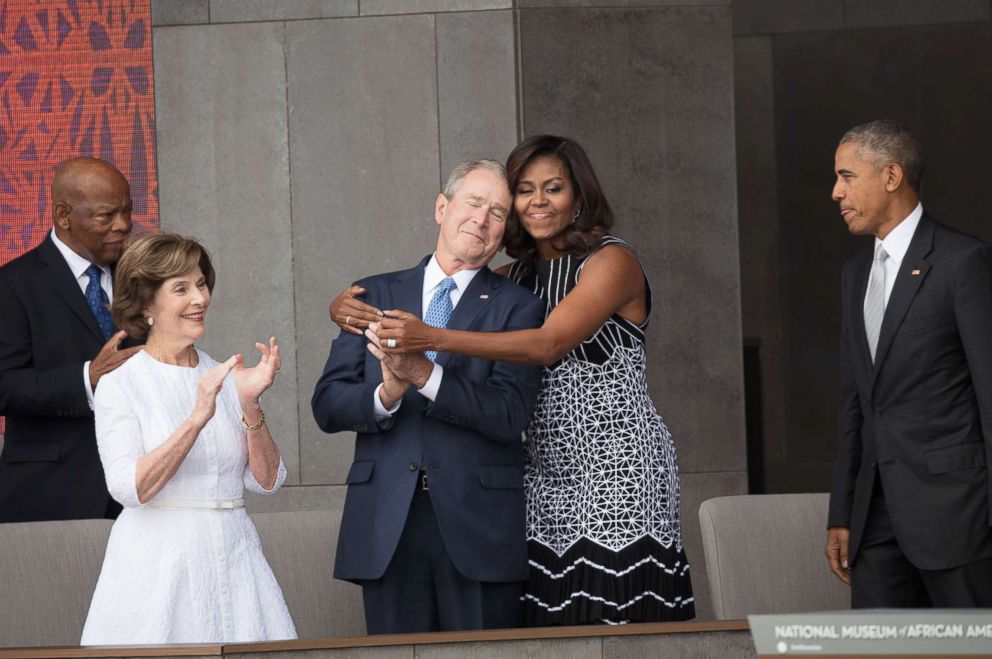 PHOTO: First Lady Michelle Obama hugs former President George W Bush at the opening of the National Museum of African American History and Culture in Washington, Sept. 24, 2016.