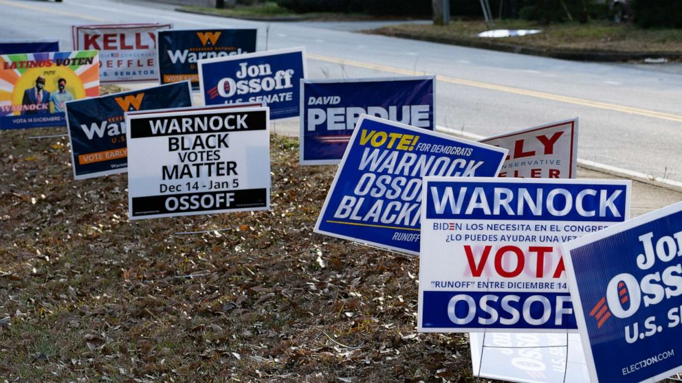 PHOTO: Signs line a road at a Gwinnett County voting location, Jan. 5, 2021, in Atlanta.