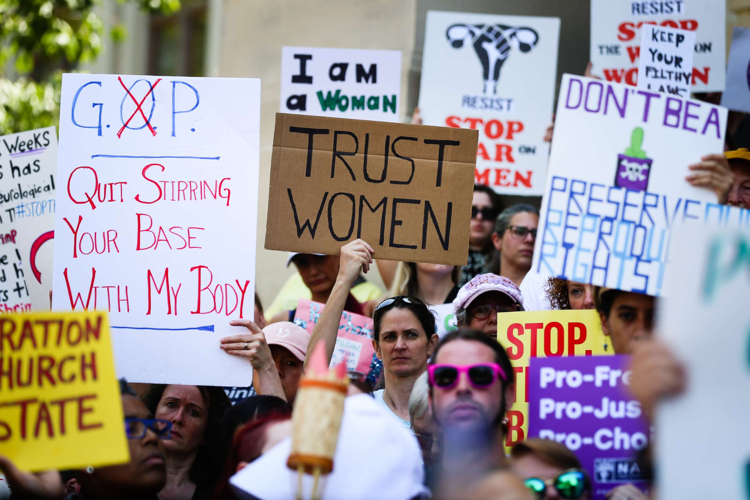 PHOTO: Women hold signs during a protest against recently passed abortion ban bills at the Georgia State Capitol building, in Atlanta, May 21, 2019.