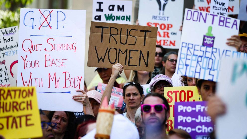 PHOTO: Women hold signs during a protest against recently passed abortion ban bills at the Georgia State Capitol building, in Atlanta, May 21, 2019.
