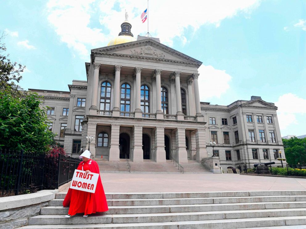 PHOTO: Activist Tamara Stevens with the Handmaids Coalition of Georgia leaves the Georgia Capitol, May 16, 2019 in Atlanta.