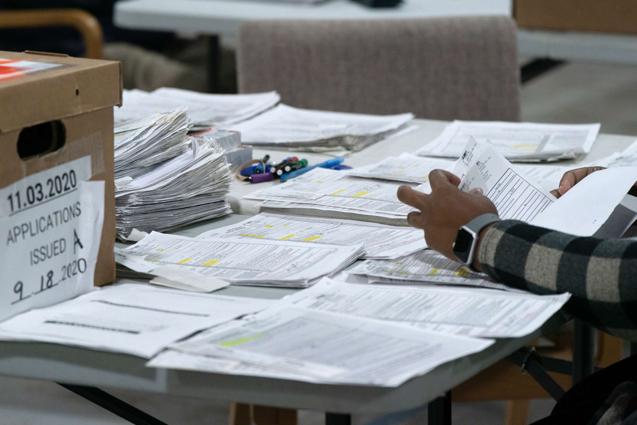PHOTO: Election personnel sort absentee  ballot applications for storage at the Gwinnett County Board of Voter Registrations and Elections offices, Nov. 7, 2020, in Lawrenceville, Ga.