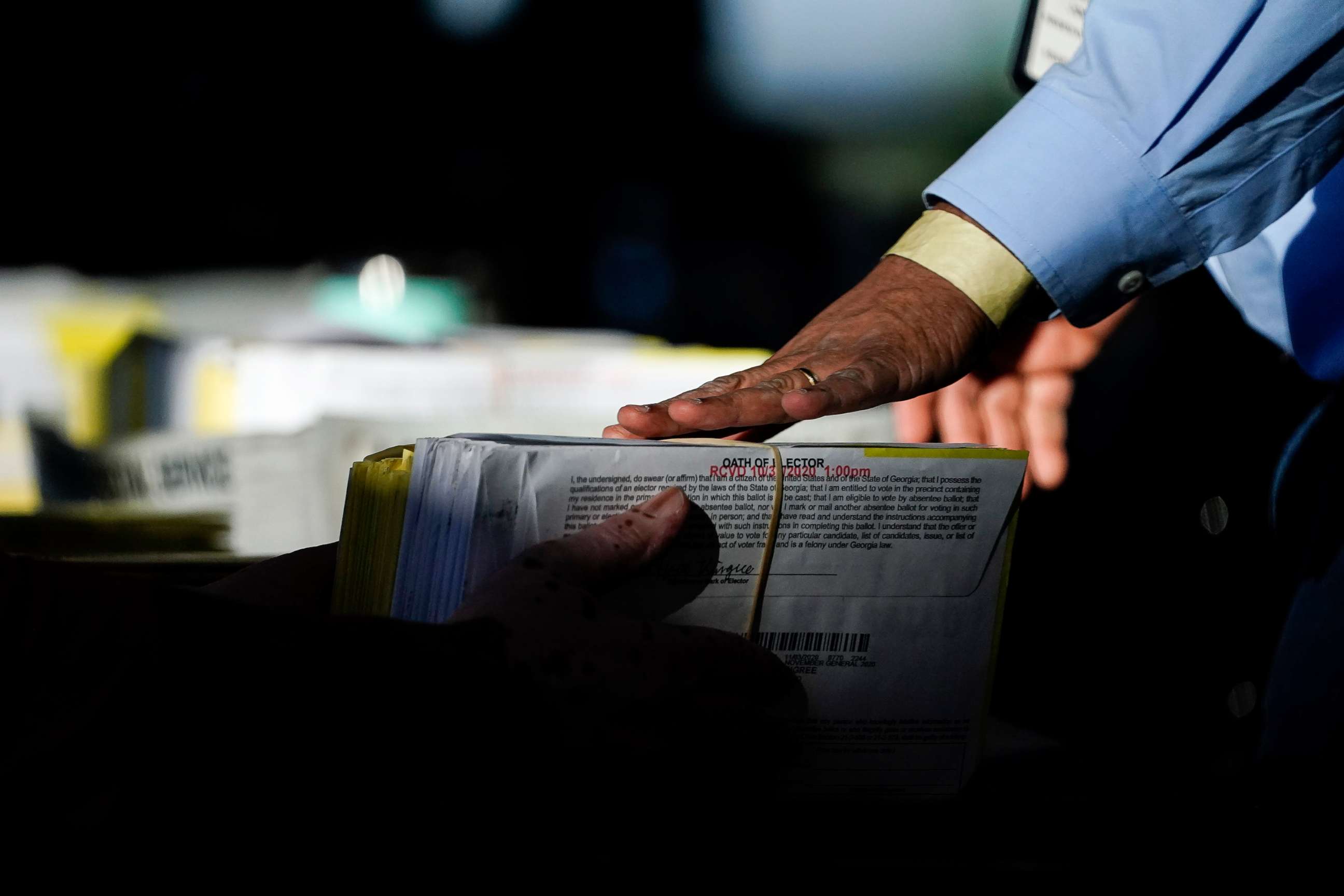PHOTO: A election worker receives ballots to count at State Farm Arena, Nov. 5, 2020, in Atlanta.
