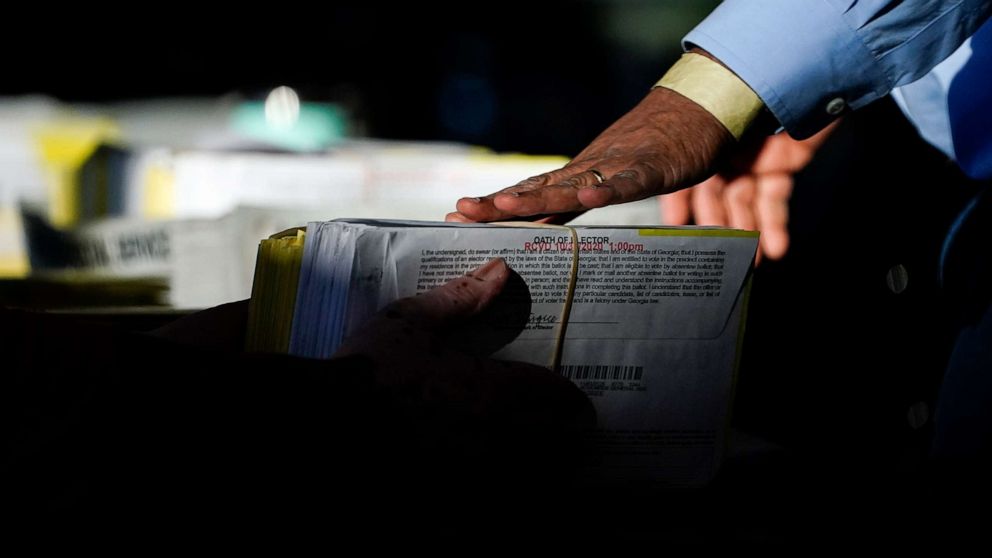PHOTO: A election worker receives ballots to count at State Farm Arena, Nov. 5, 2020, in Atlanta.