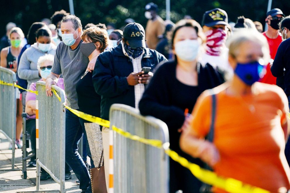 PHOTO: Voters line up to cast their election ballot at a Cobb County polling station in Marietta, Ga., Oct. 13, 2020. 