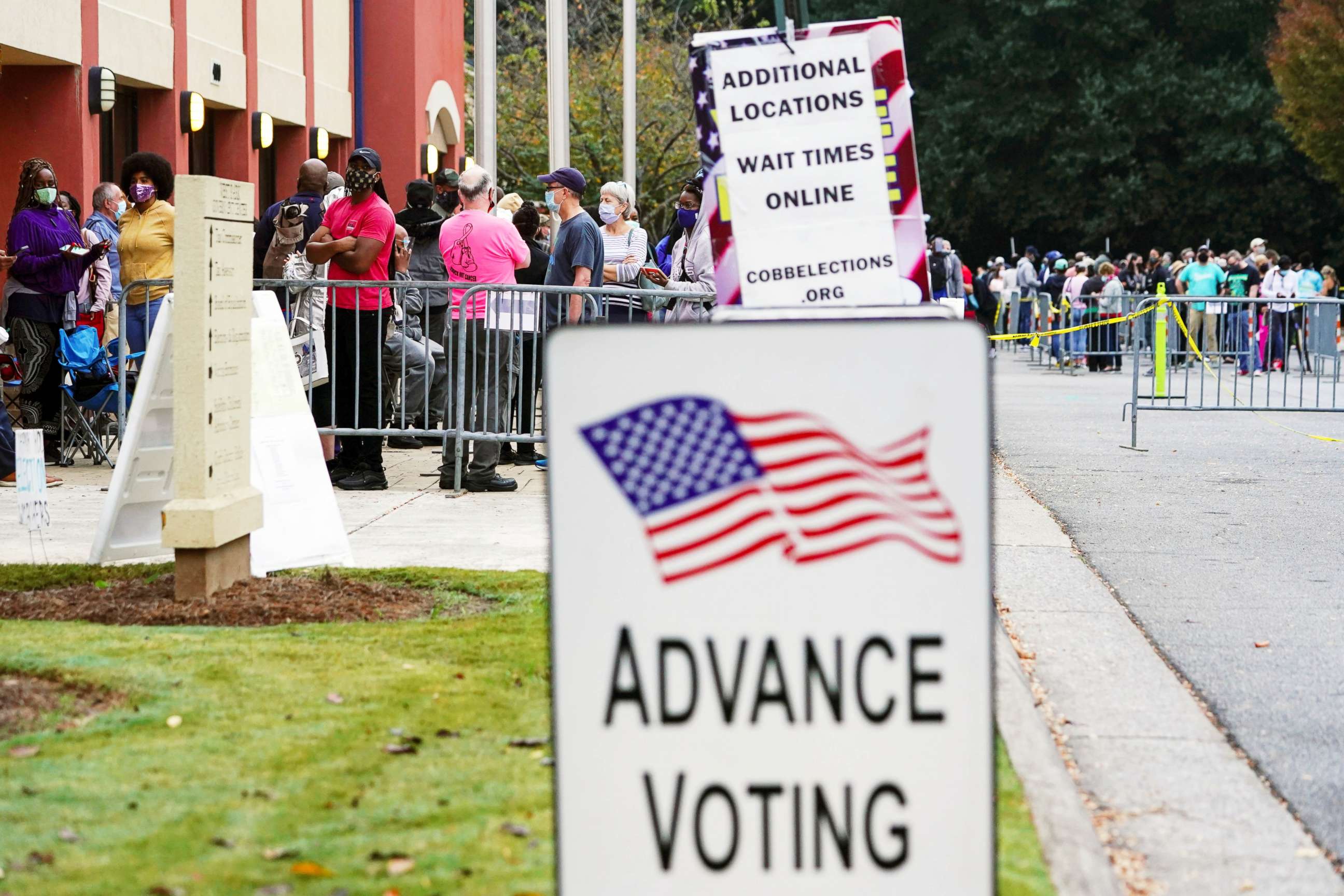 PHOTO: Voters line up to cast their election ballot at a Cobb County polling station during early voting in Marietta, Ga., Oct. 13, 2020.