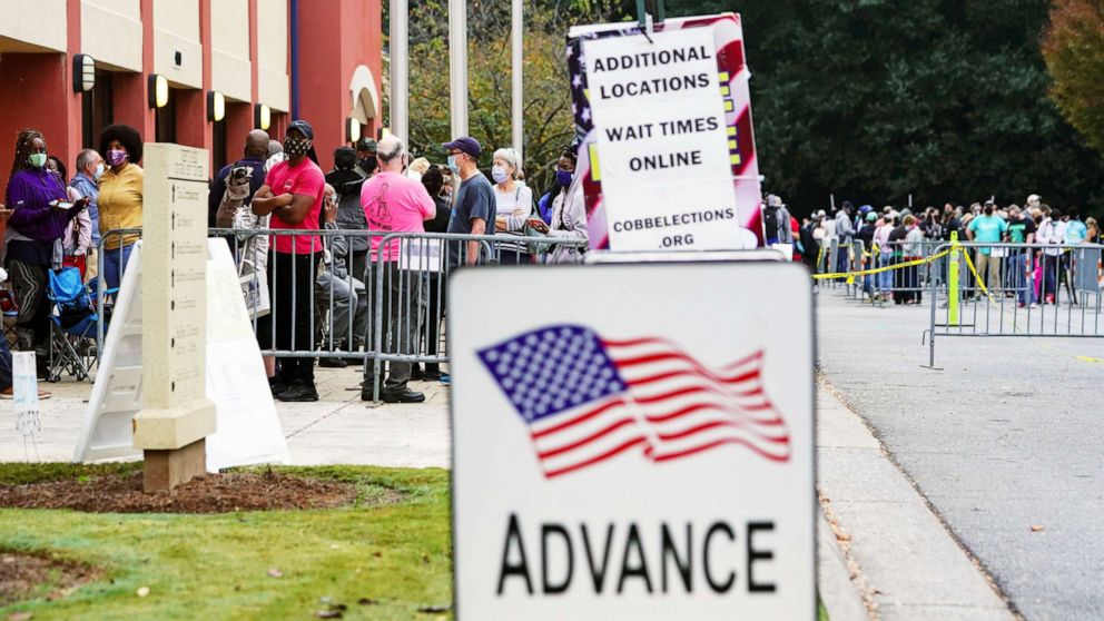 PHOTO: Voters line up to cast their election ballot at a Cobb County polling station in Marietta, Ga., Oct. 13, 2020.