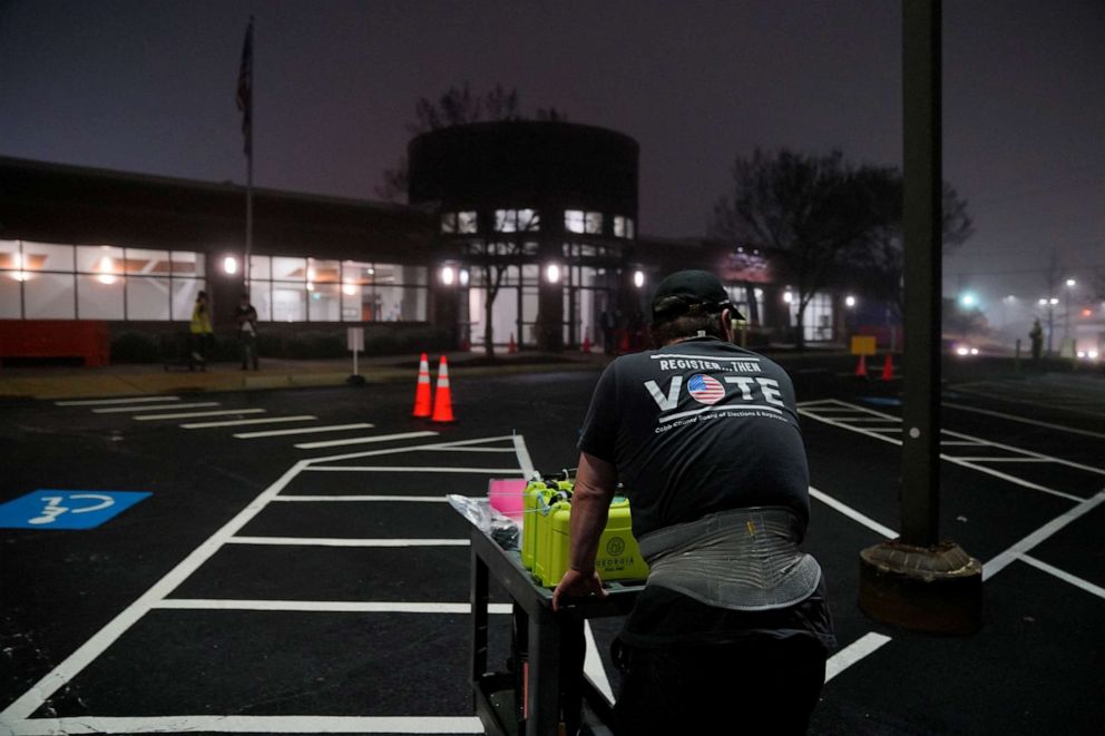 PHOTO: Election workers unload ballots as they arrive from precincts at the Cobb County Elections and Registration Center, Dec. 6, 2022, in Marietta, Ga.