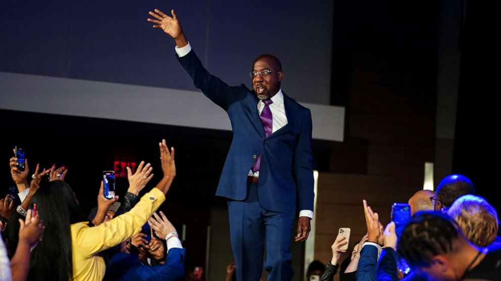 PHOTO: Democratic Sen. Raphael Warnock arrives on stage to speak during an election night watch party, Dec. 6, 2022, in Atlanta. 