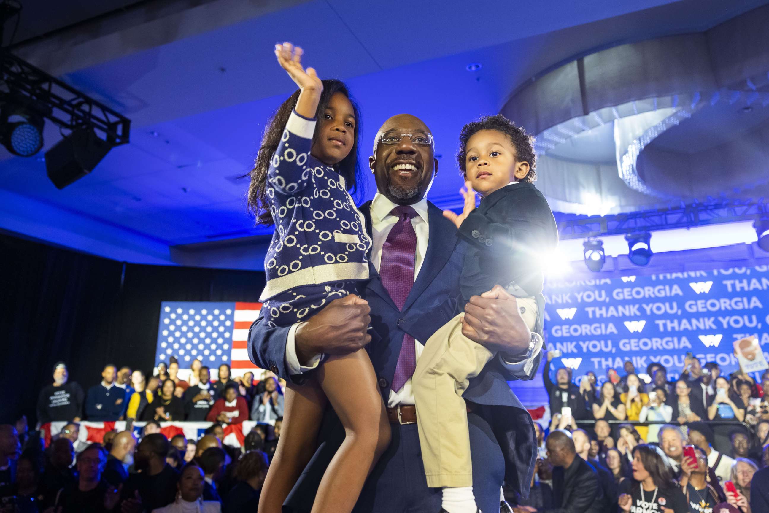 PHOTO: Senator Raphael Warnock holds his two children Chloe and Caleb after he was reelected to the Senate in Atlanta, Dec. 6 2022.