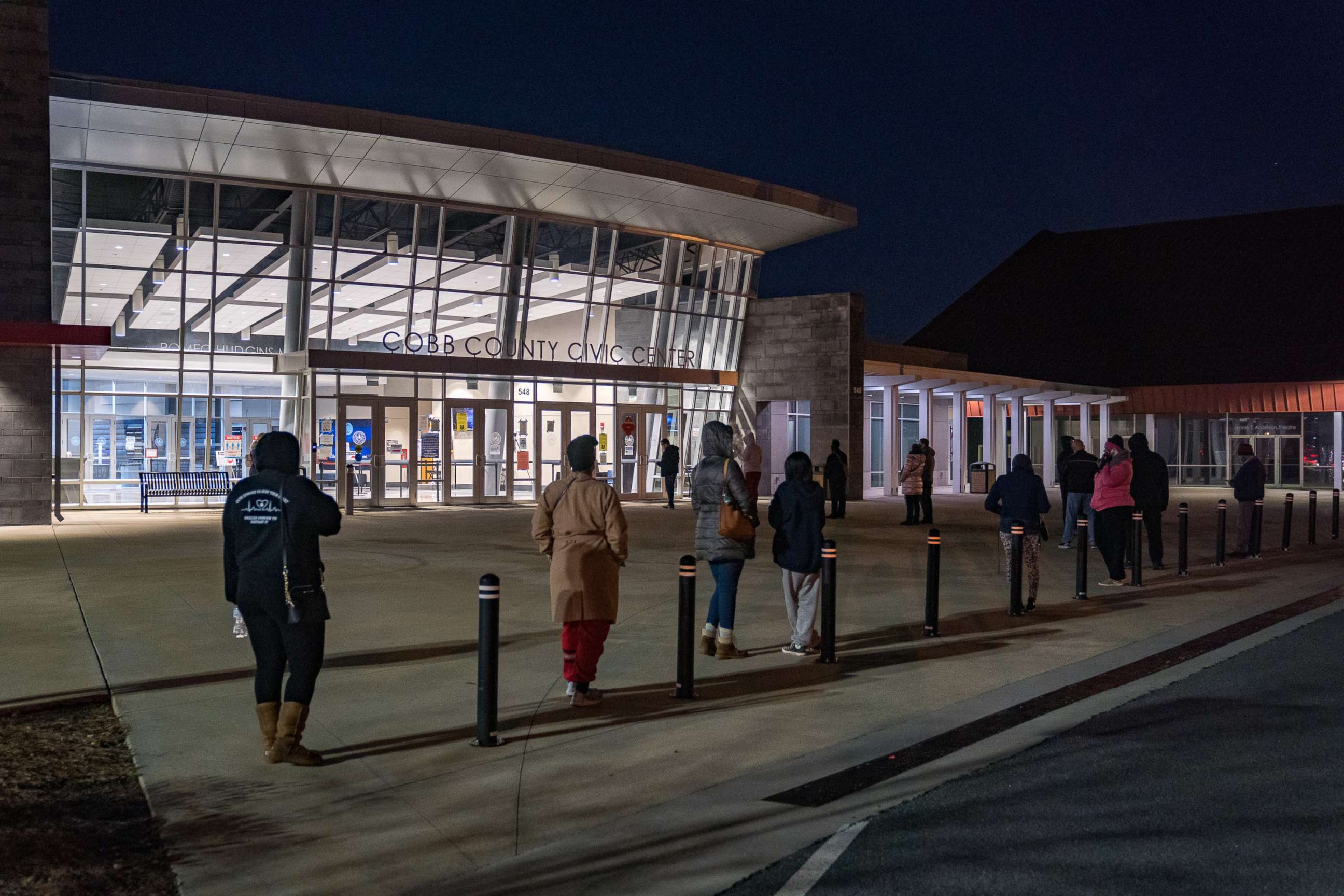 PHOTO: Voters stand in line before the doors open at Cobb County Community Center on Jan. 5, 2021, in Atlanta.