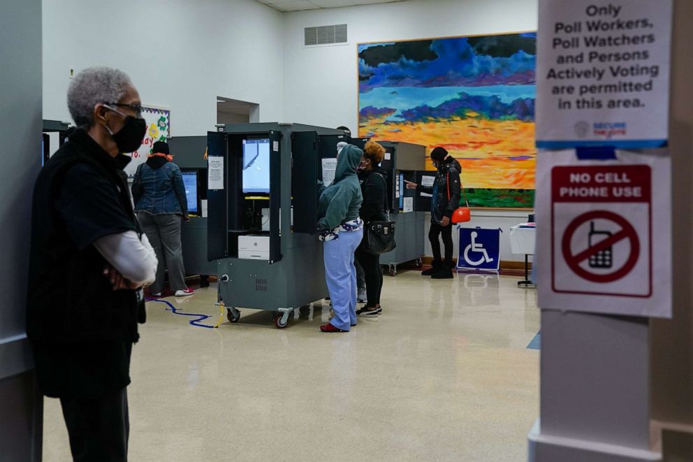 PHOTO: Voters wearing protective masks cast ballots at a polling location for the 2020 Presidential election in College Park, Ga., Nov. 3, 2020.