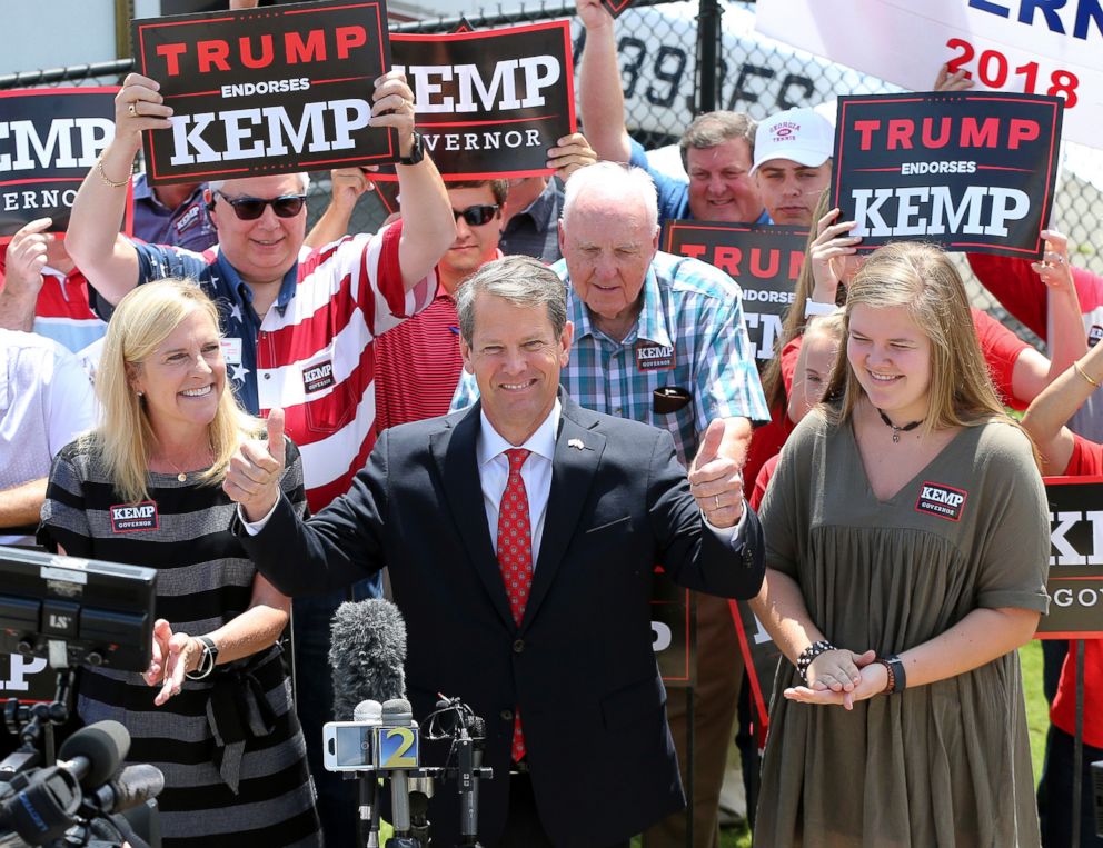 PHOTO: Secretary of State Brian Kemp, with his wife Marty and daughter Lucy, gives the double thumbs up making his first campaign stop during his Putting Georgians First Fly Around at Peachtree DeKalb Airport, July 23, 2018, in Atlanta. 