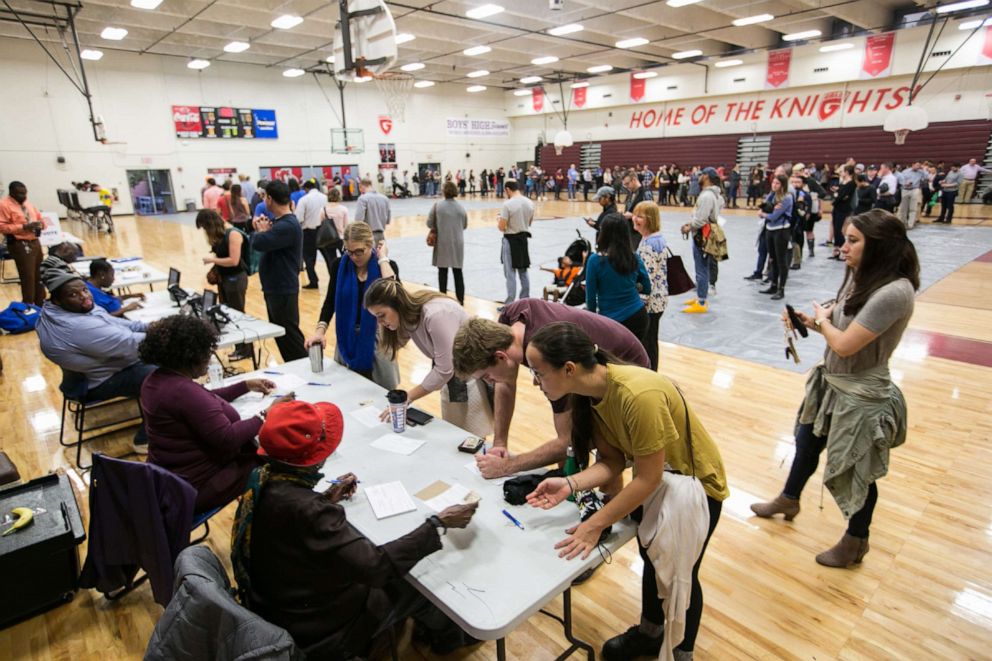 PHOTO: Voters line up to cast their ballots at a polling station set up at Grady High School for the mid-term elections on in Atlanta, Nov. 6, 2018.