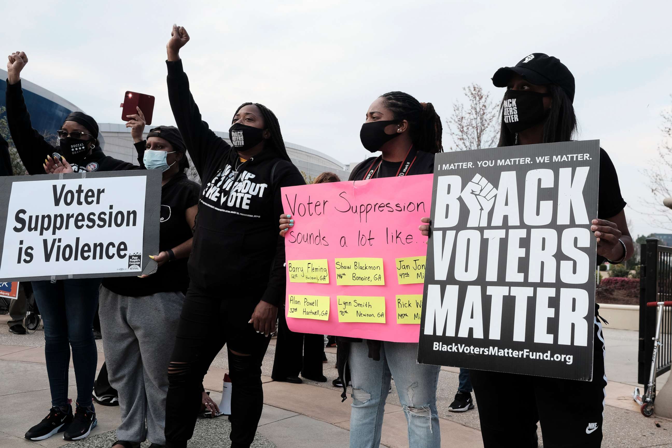 PHOTO: People hold a rally outside of the World Of Coca-Cola museum in Atlanta, March 15, 2021, protesting the Coca-Cola corporation's donations to several politicians who are in support of bills that advocates believe are an attempt at voter suppression.
