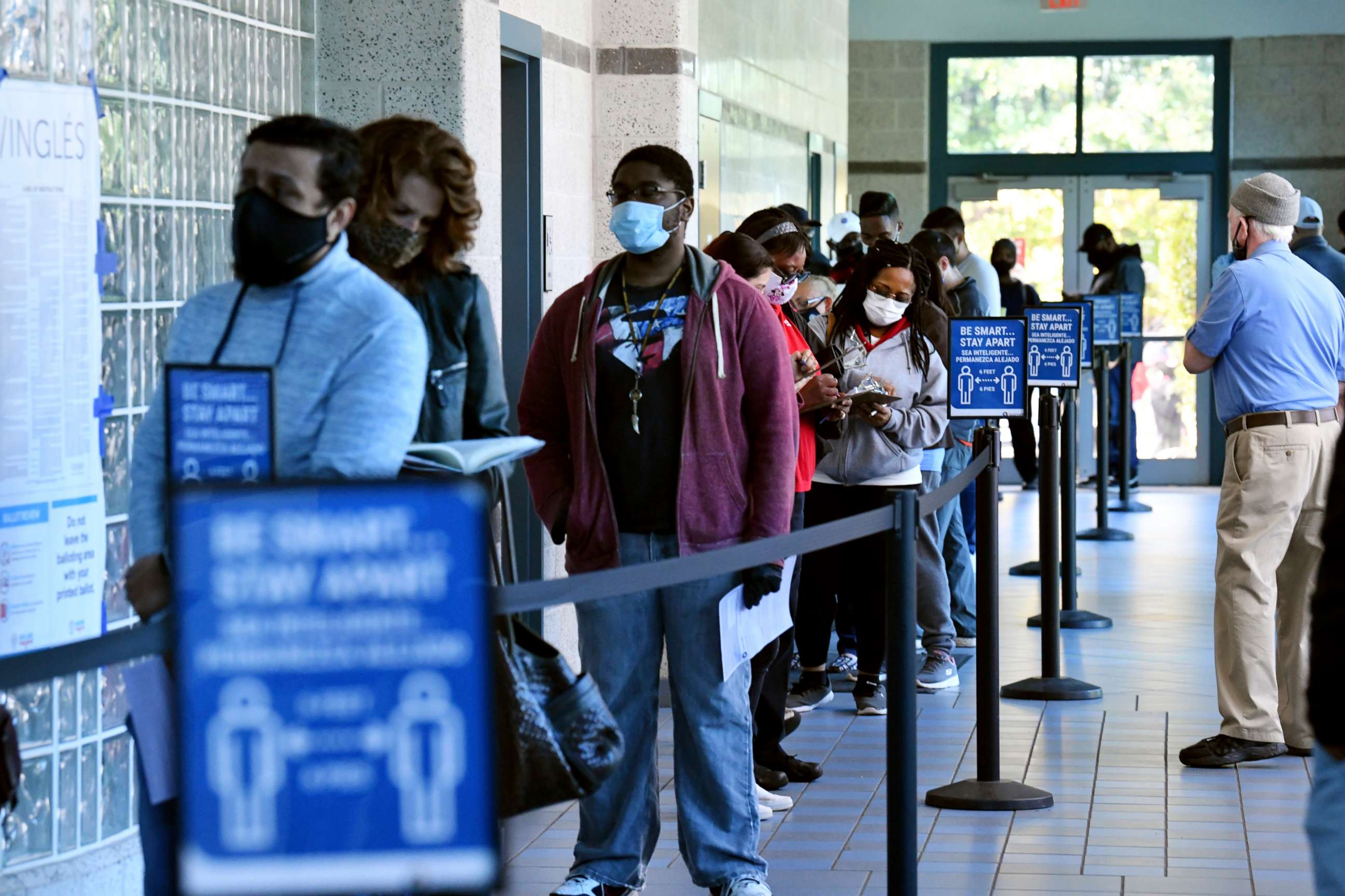 PHOTO: Gwinnett County voters wait in line to cast their early ballots for the general election at the Lucky Shoals Park Community Recreation Center in Norcross, Ga., on the last day of early voting on Friday, Oct. 30, 2020.