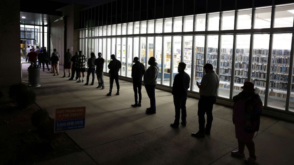 PHOTO: Residents wait in line to vote early outside a polling station, Nov. 29, 2022 in Atlanta.