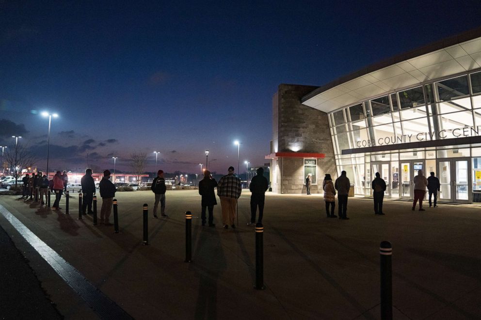 PHOTO: Voters stand in line before the doors open at Cobb County Community Center, Jan. 5, 2021, in Atlanta.