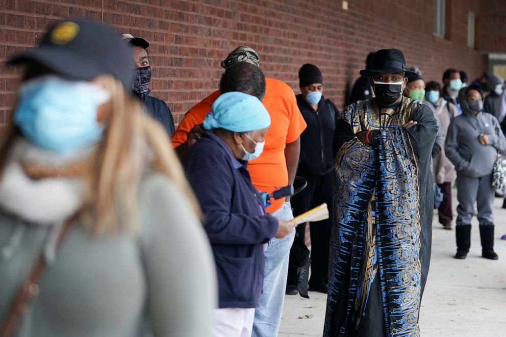 PHOTO: Early voters queue to cast their votes in two run-off elections that will determine control of the U.S. Senate in Atlanta, Dec. 14, 2020.