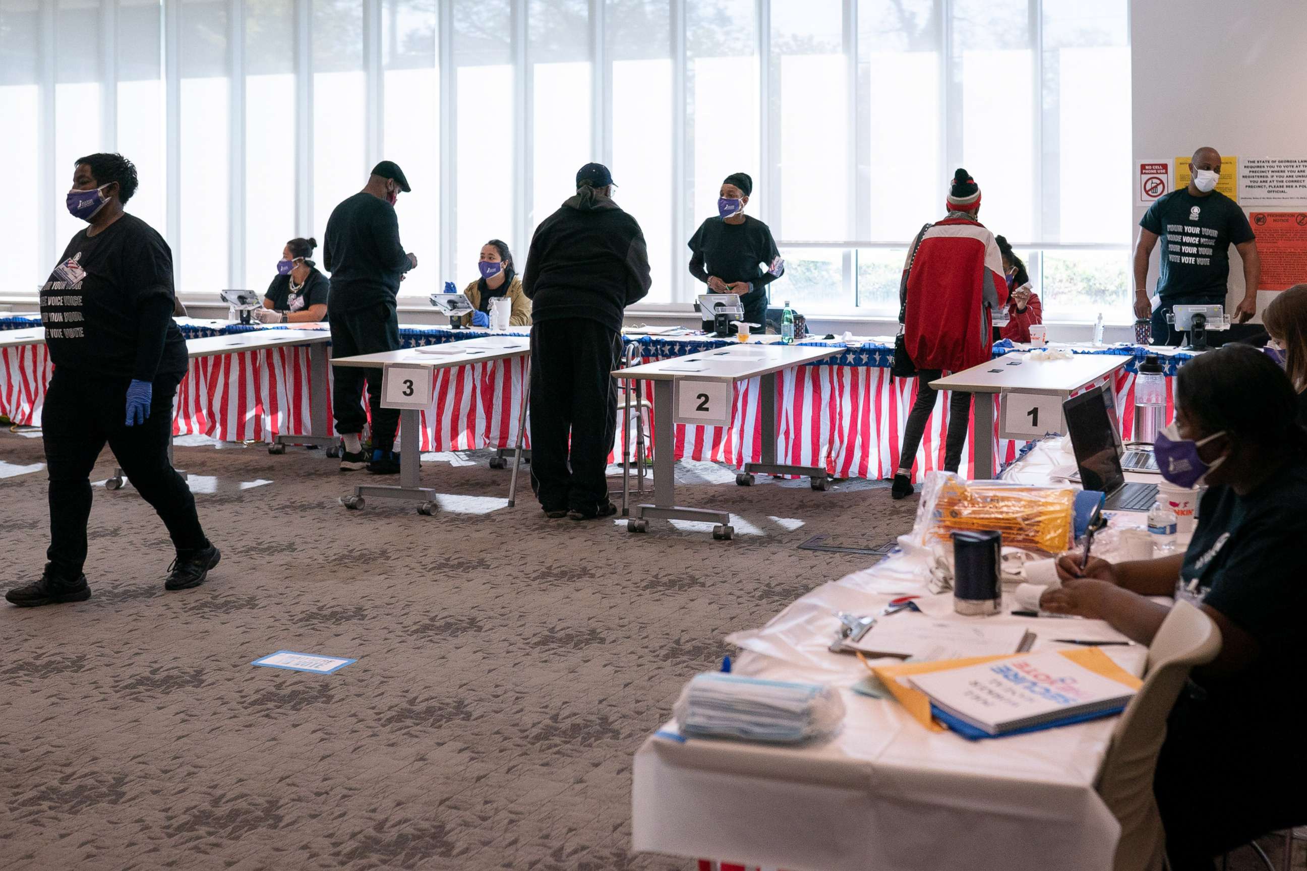 PHOTO: Voters check in with poll workers at a polling location for the 2020 Presidential election in Atlanta, on Nov. 3, 2020.