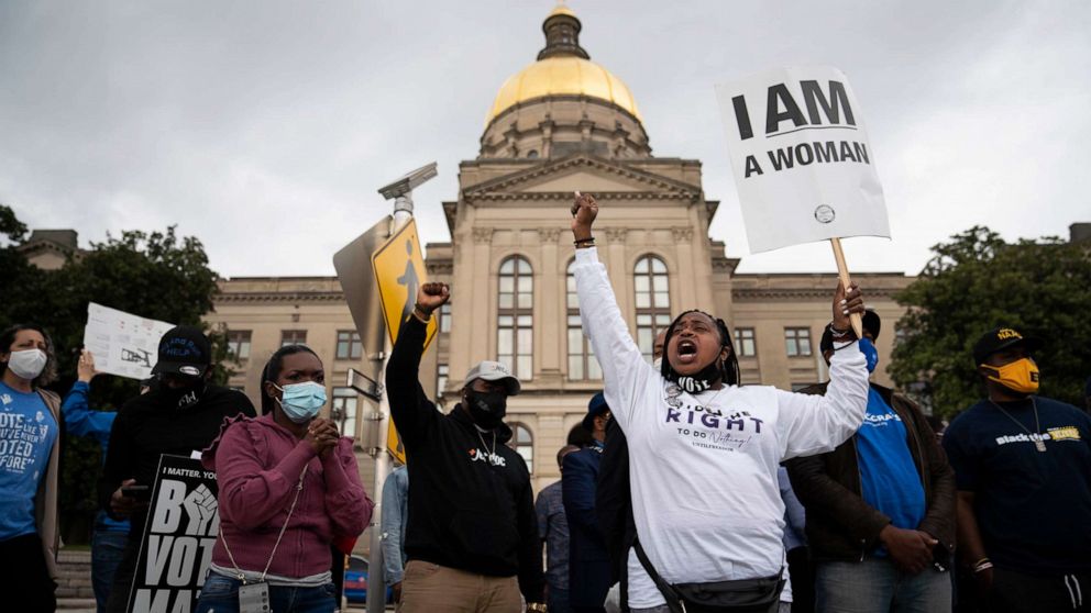 PHOTO: People protest outside the Georgia Capitol in Atlanta against a House bill on voting restrictions, March 25, 2021.