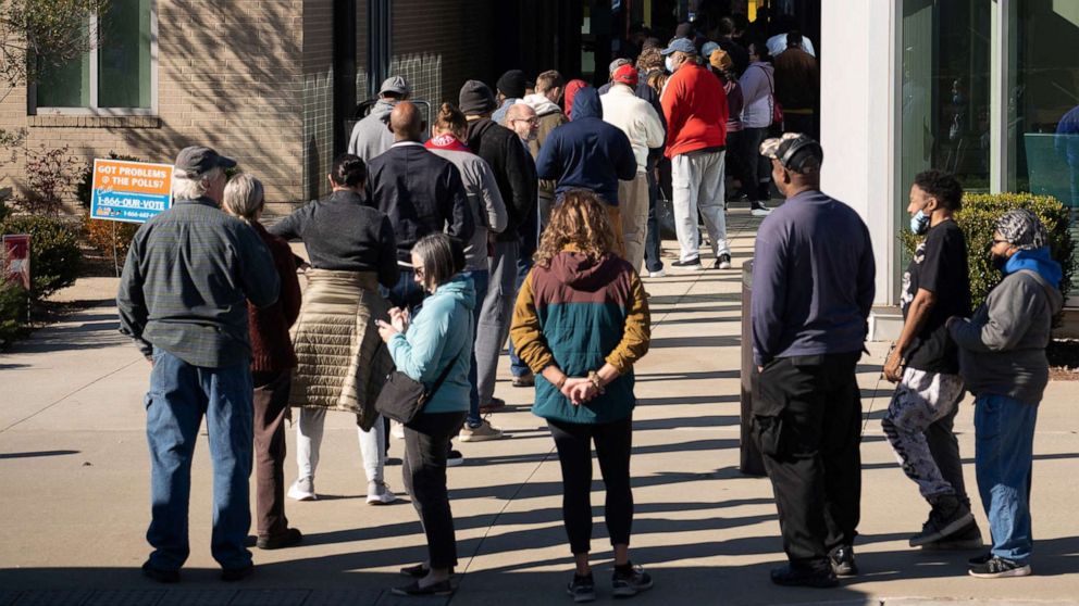 At least 352,953 people voted in person on Friday, setting a new record for a single-day early in-person turnout before next week's Senate runoff. 