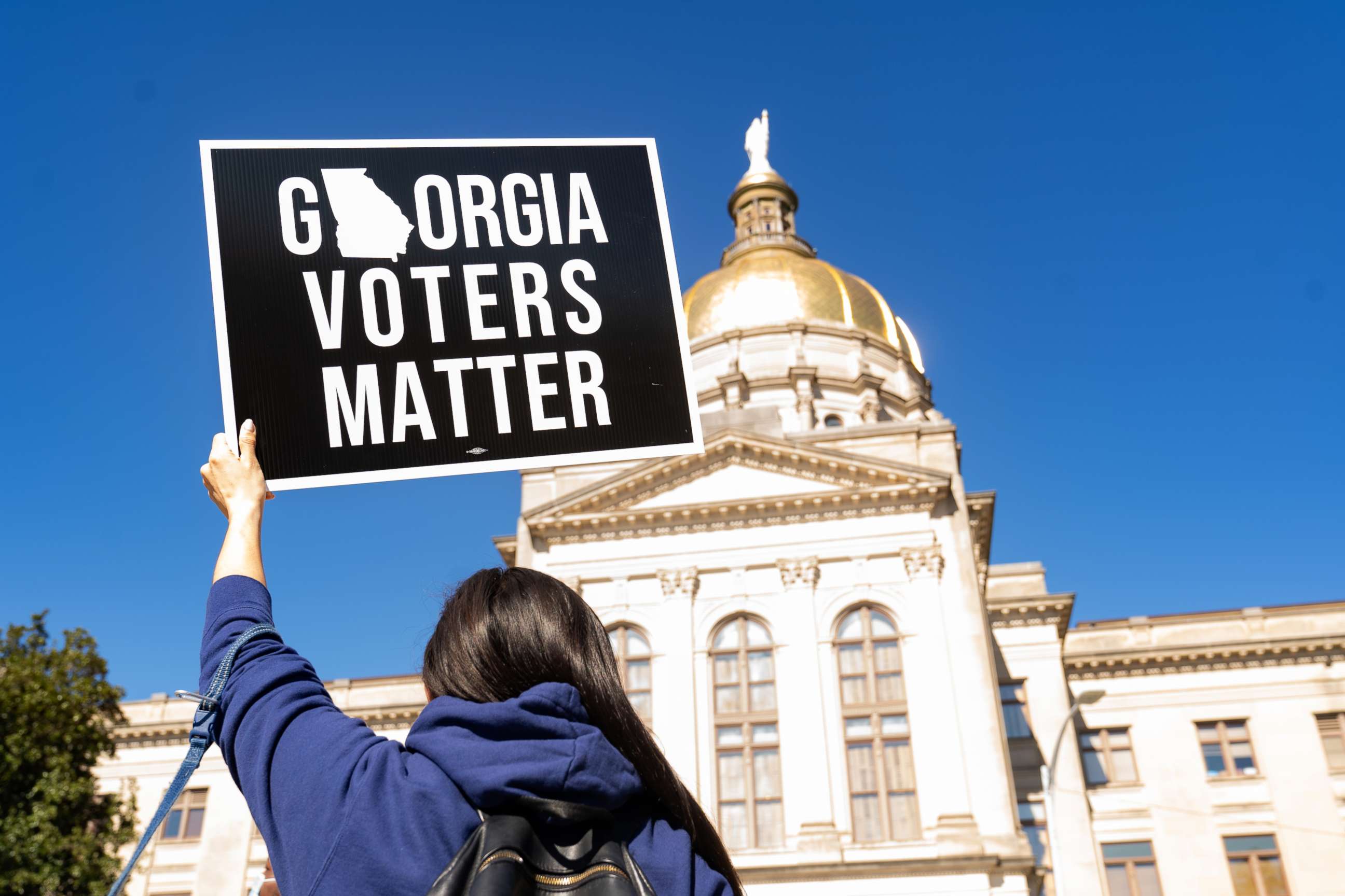 PHOTO: Demonstrators stand outside of the Georgia Capitol building, to oppose the HB 531 bill, March 3, 2021, in Atlanta.