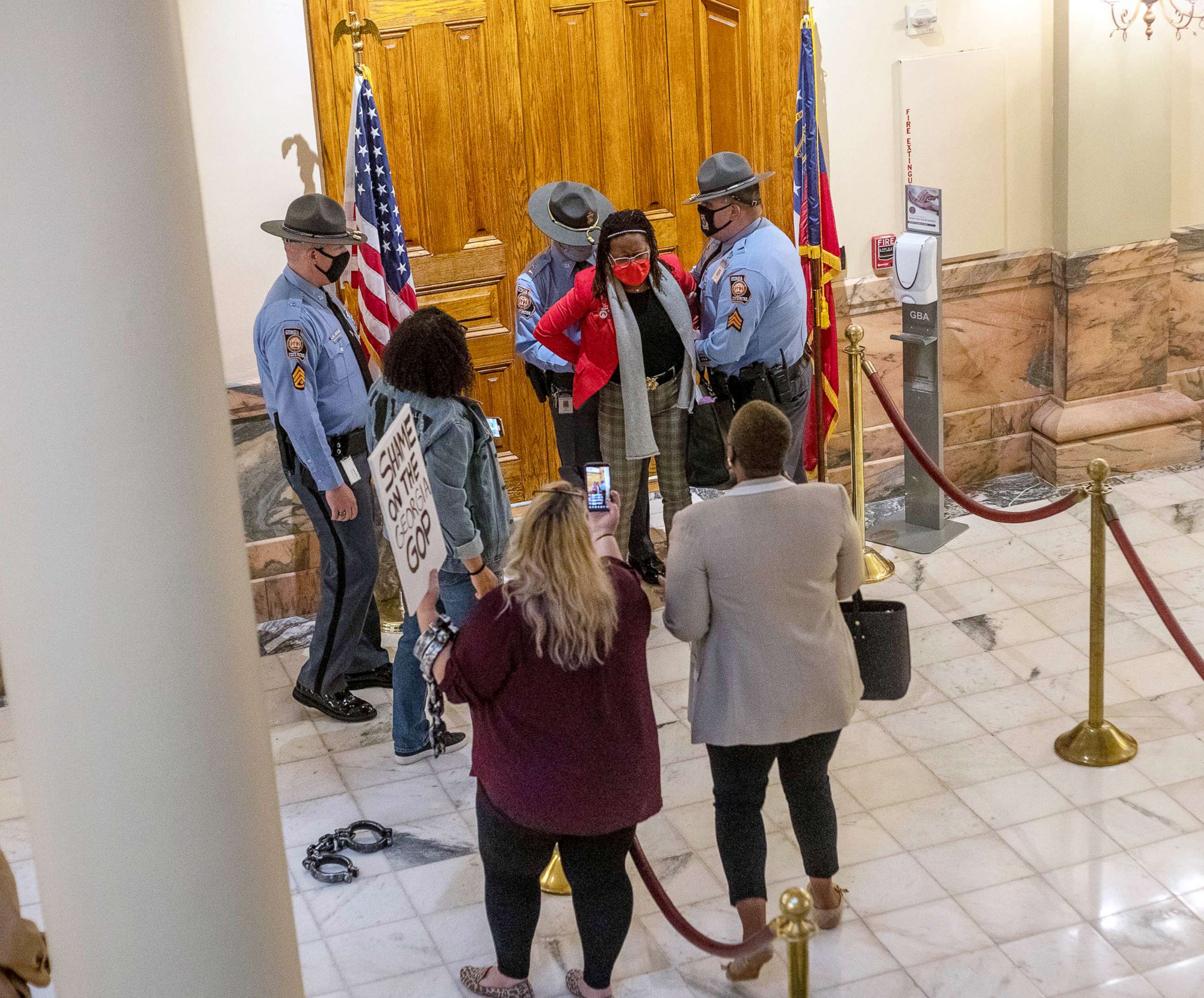 PHOTO: Rep. Park Cannon is placed in handcuffs by Georgia State Troopers after being asked to stop knocking on a door that leads to Gov. Brian Kemp's office while Gov. Kemp was signing SB 202 in the Ga. State Capitol Building in Atlanta, March 25, 2021.