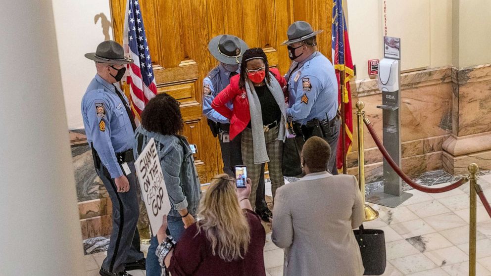 PHOTO: Rep. Park Cannon is placed in handcuffs by Georgia State Troopers after being asked to stop knocking on a door that leads to Gov. Brian Kemp's office while Gov. Kemp was signing SB 202 in the Ga. State Capitol Building in Atlanta, March 25, 2021.
