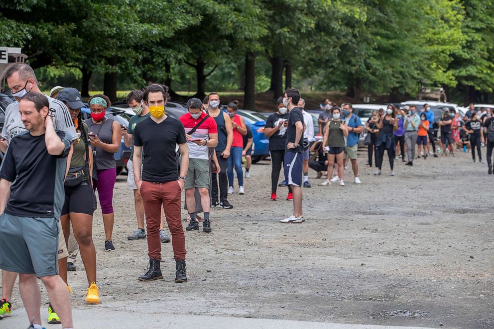 PHOTO: Voters wait in an hours long line to vote at Fulton County's Park Tavern precinct in the coronavirus-delayed Georgia presidential preference primary election in Atlanta, June 9, 2020.