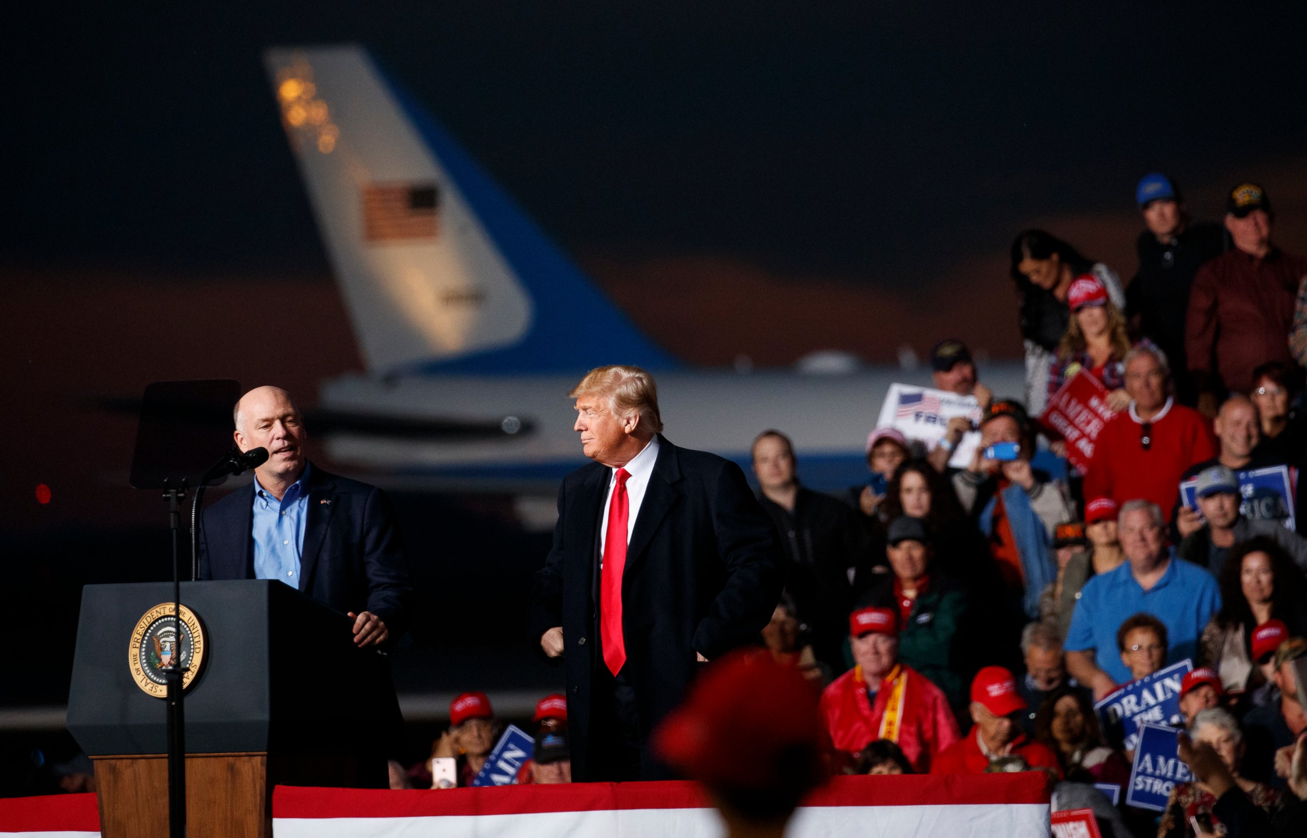 PHOTO: Rep. Greg Gianforte, R-Mont., speaks as President Donald Trump stands right during a campaign rally at Minuteman Aviation Hangar, Thursday, Oct. 18, 2018, in Missoula, Mont.