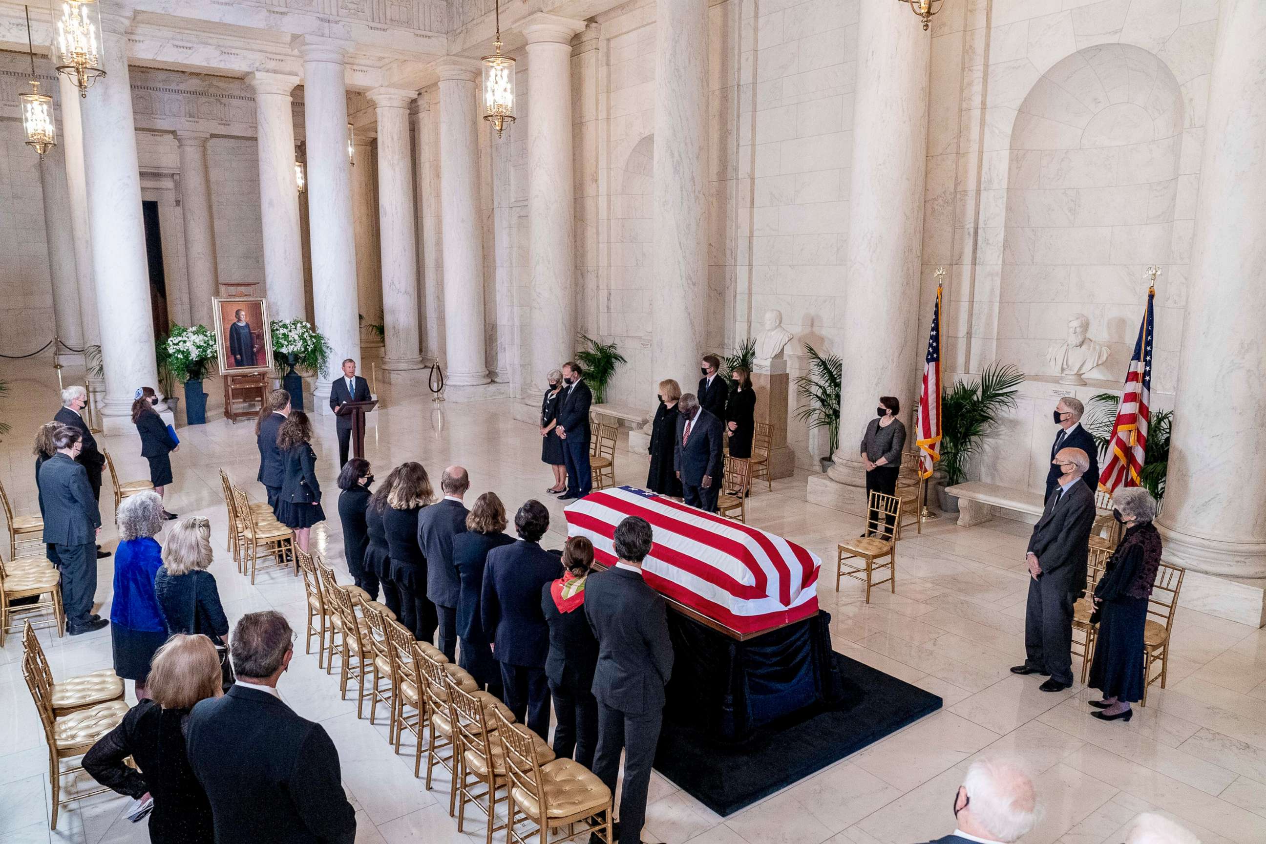 PHOTO: The flag-draped casket of Justice Ruth Bader Ginsburg is visible as Chief Justice of the United States John Roberts speaks during a private ceremony at the Supreme Court in Washington, D.C., Sept. 23, 2020.