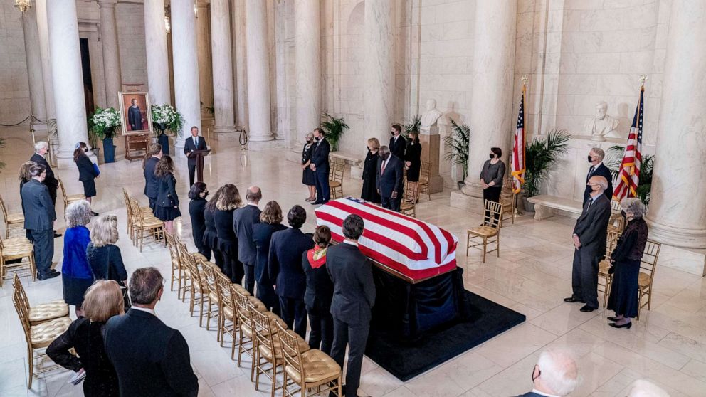 PHOTO: The flag-draped casket of Justice Ruth Bader Ginsburg is visible as Chief Justice of the United States John Roberts speaks during a private ceremony at the Supreme Court in Washington, D.C., Sept. 23, 2020.