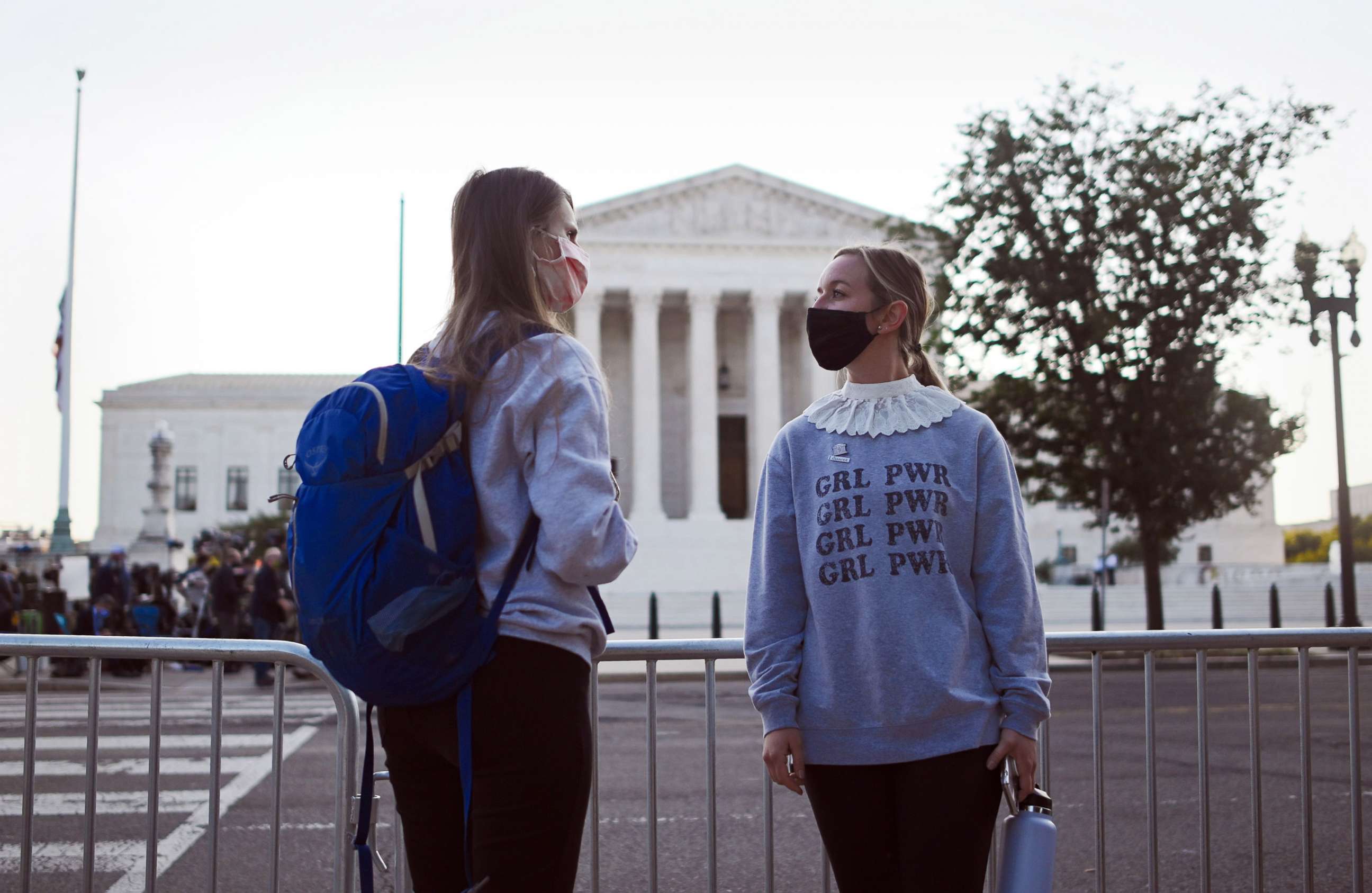 PHOTO: Women wait for the arrival of the casket of Justice Ruth Bader Ginsburg at the Supreme Court for a private  ceremony and two days of public viewing, Sept. 23, 2020, in Washington, D.C.