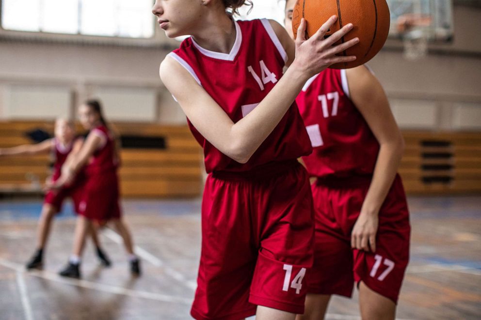 PHOTO: Young women play basketball in this stock photo.