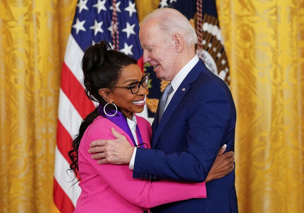 PHOTO: National Medal of Arts recipient singer Gladys Knight hugs President Joe Biden as he presents her the medal during a ceremony in the East Room at the White House in Washington, D.C., March 21, 2023.