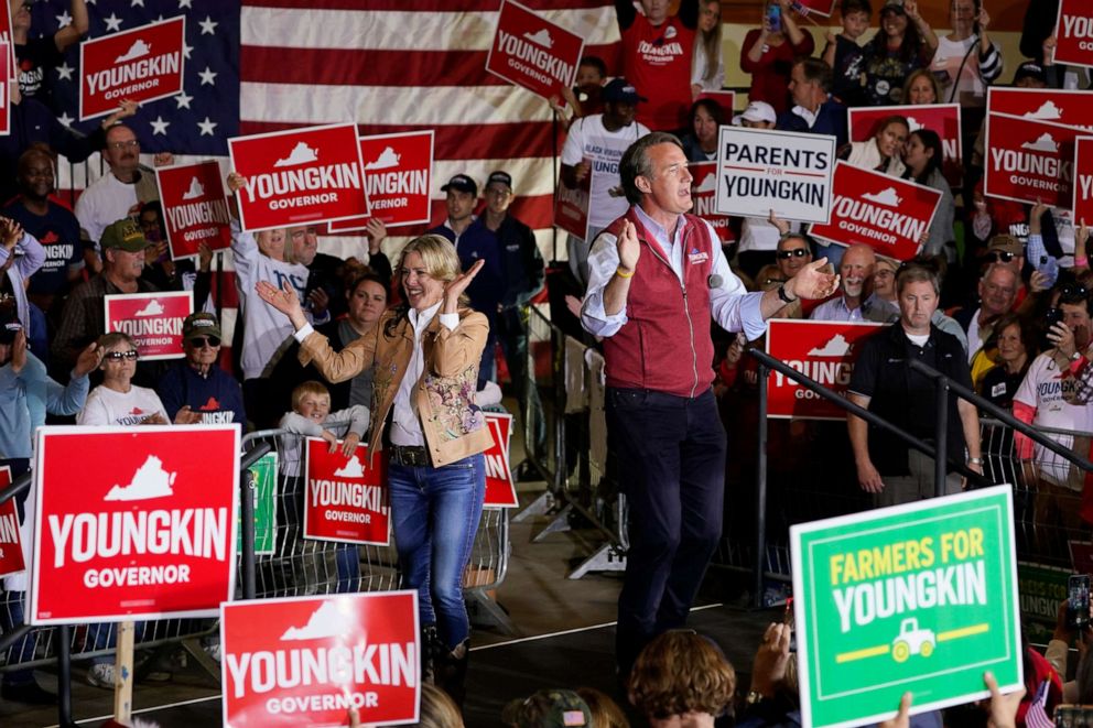 PHOTO: Republican gubernatorial candidate Glenn Youngkin, right, and his wife Suzanne, arrive for a rally in Chesterfield, Va., Nov. 1, 2021.