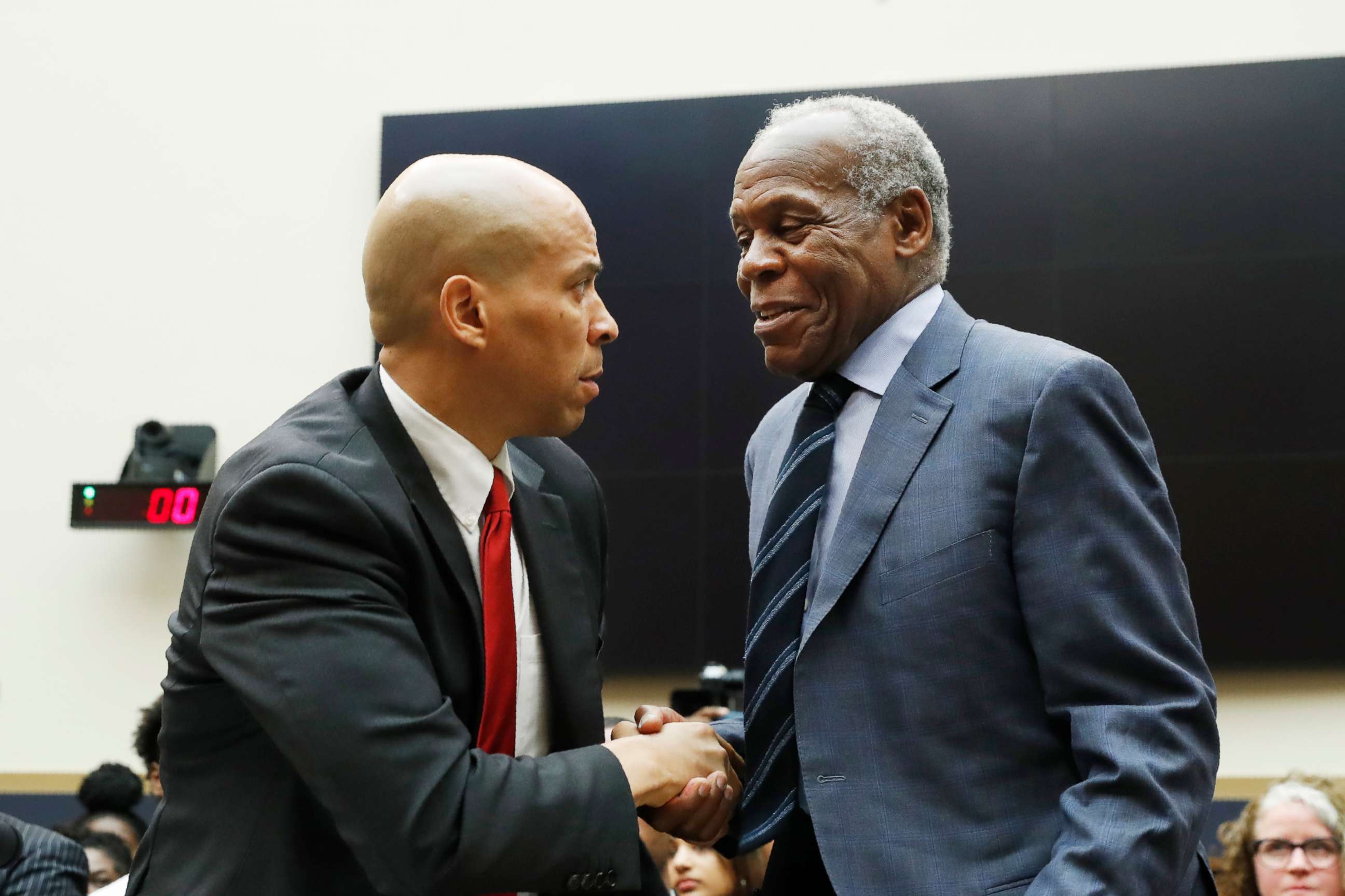 PHOTO: Sen. Cory Booker, left, greets Danny Glover, before they testify about reparations for the descendants of slaves, during a hearing before the House Judiciary Subcommittee in Washington, June 19, 2019.