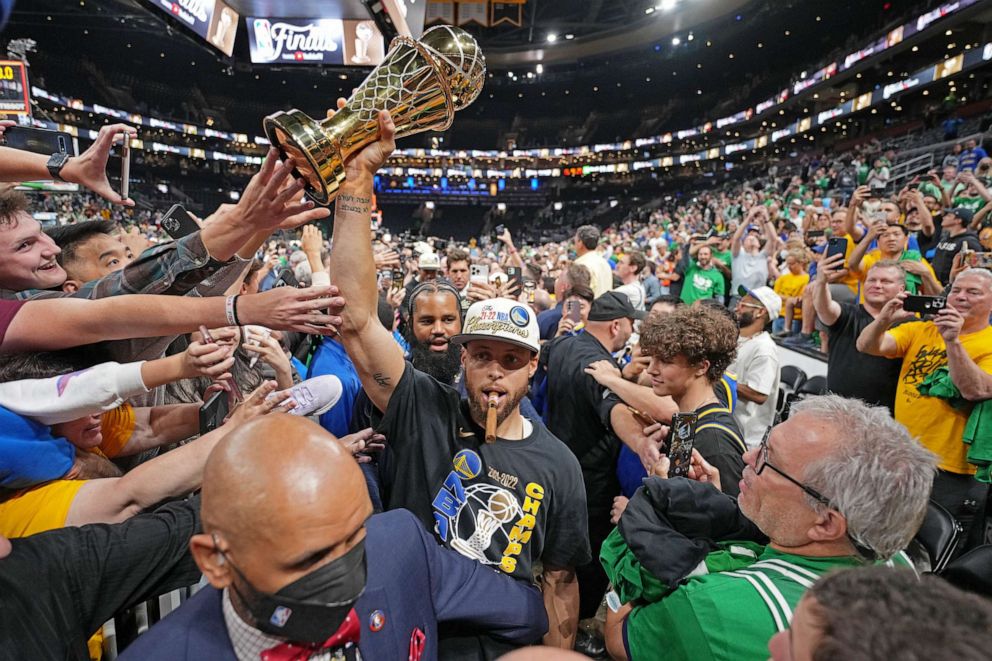PHOTO: FILE - Stephen Curry #30 of the Golden State Warriors celebrates with the Bill Russell Finals MVP Trophy after winning during Game Six of the 2022 NBA Finals, June 16, 2022 at TD Garden in Boston.