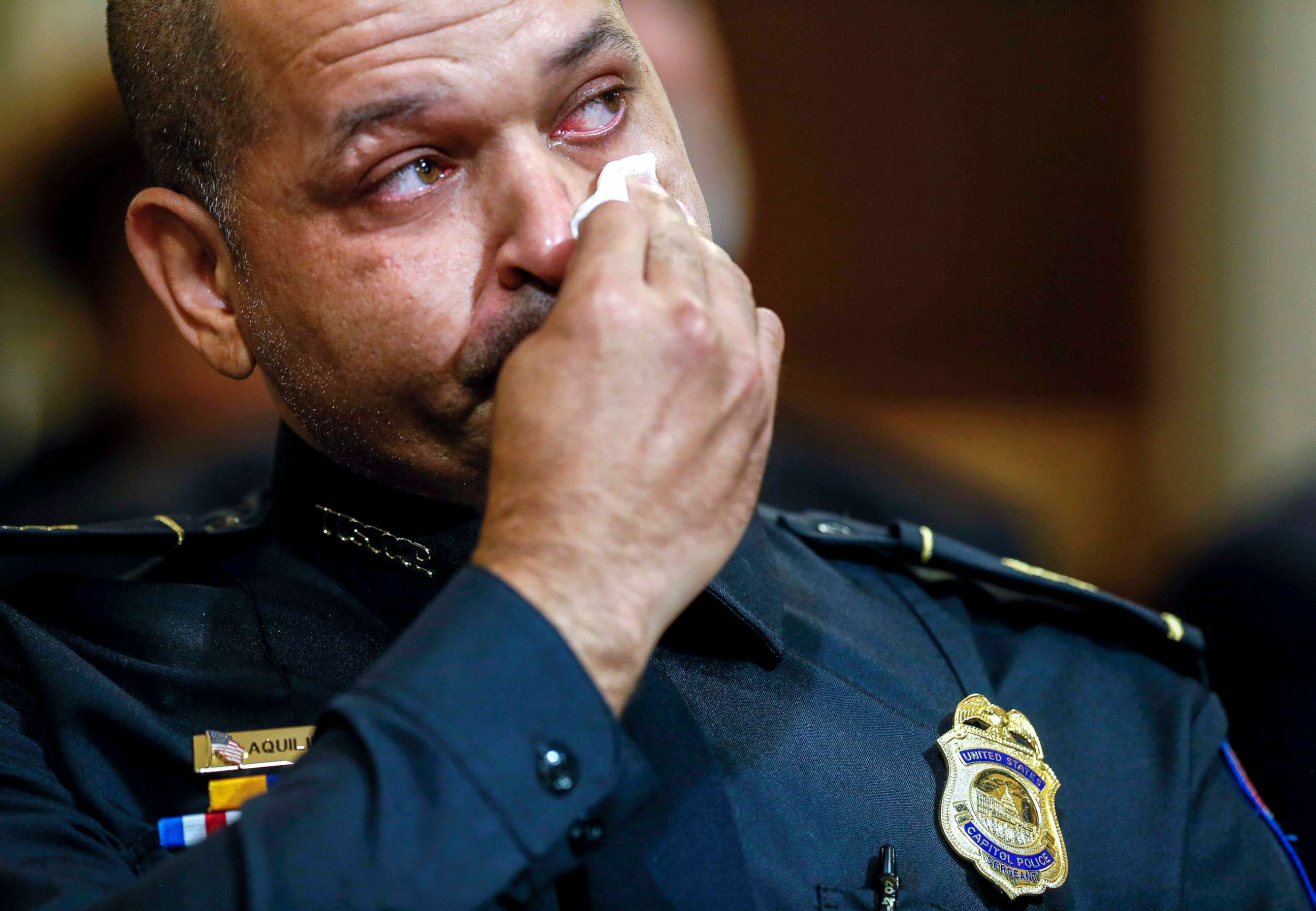 PHOTO: U.S. Capitol Police Sgt. Aquilino Gonell wipes his eye as he watches a video being displayed during a House select committee hearing on the Jan. 6 attack on Capitol Hill in Washington, D.C., July 27, 2021.