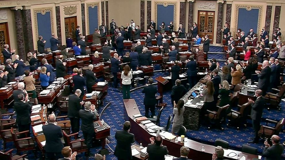 PHOTO: U.S. Capitol Police Officer Eugene Goodman (top) acknowledges a standing ovation, during the fourth day of the impeachment trial of the former president on charges of inciting the deadly attack on the U.S. Capitol, Feb. 12, 2021.