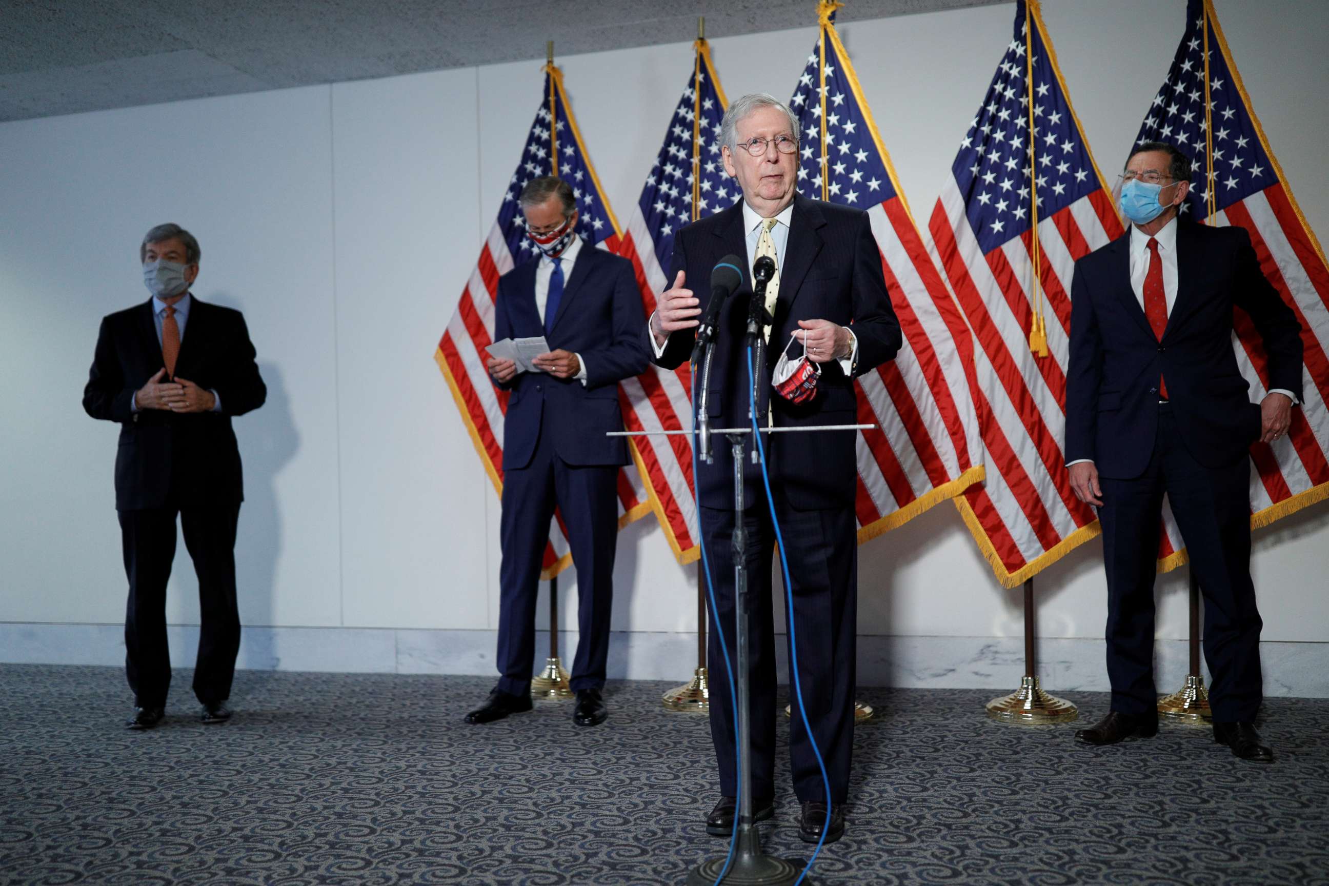 PHOTO: Senators Roy Blunt, John Thune and John Barrasso look on as Senate Majority Leader Mitch McConnell takes questions from news reporters following a closed-door policy luncheon with fellow Republicans, on Capitol Hill in Washington, July 21, 2020.