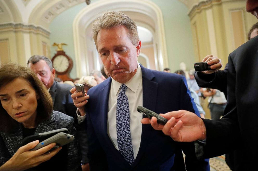 PHOTO: Sen. Jeff Flake, a member of the Judiciary Committee, walks past members of the media as he heads to Senate Chamber floor on Capitol Hill in Washington, Sept. 18, 2018.