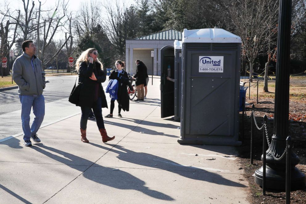 PHOTO: With the regular bathrooms closed during the government shutdown, tourists wait in line for port-a-potties while visiting the World War II Memorial, Dec. 26, 2018, in Washington.