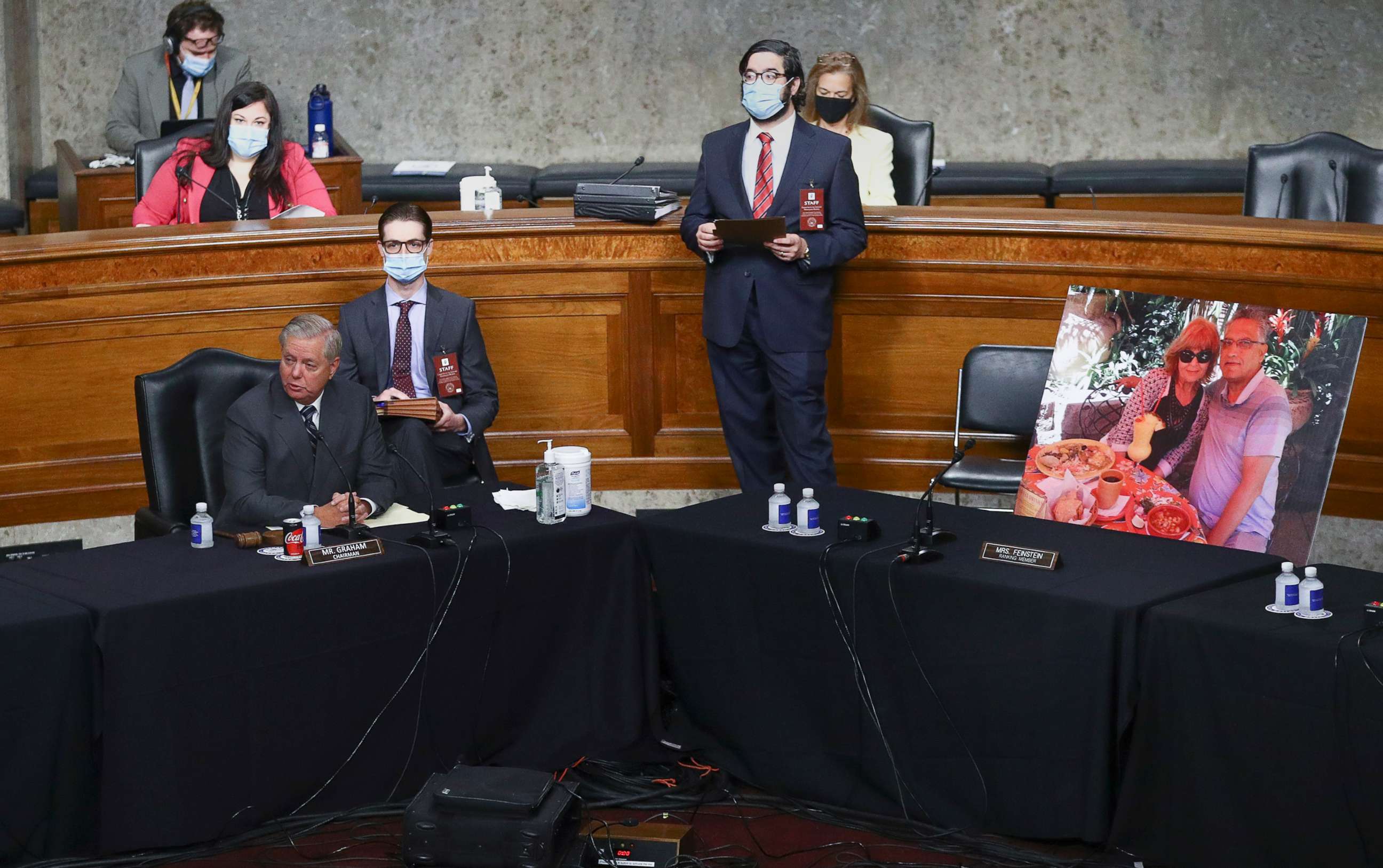 PHOTO: Senate Judiciary Committee Chairman Sen. Lindsey Graham, presides next to an image of people who've been helped by the Affordable Care Act, occupying the seat of Sen. Dianne Feinstein, during the Senate Judiciary Committee meeting, Oct. 22, 2020.