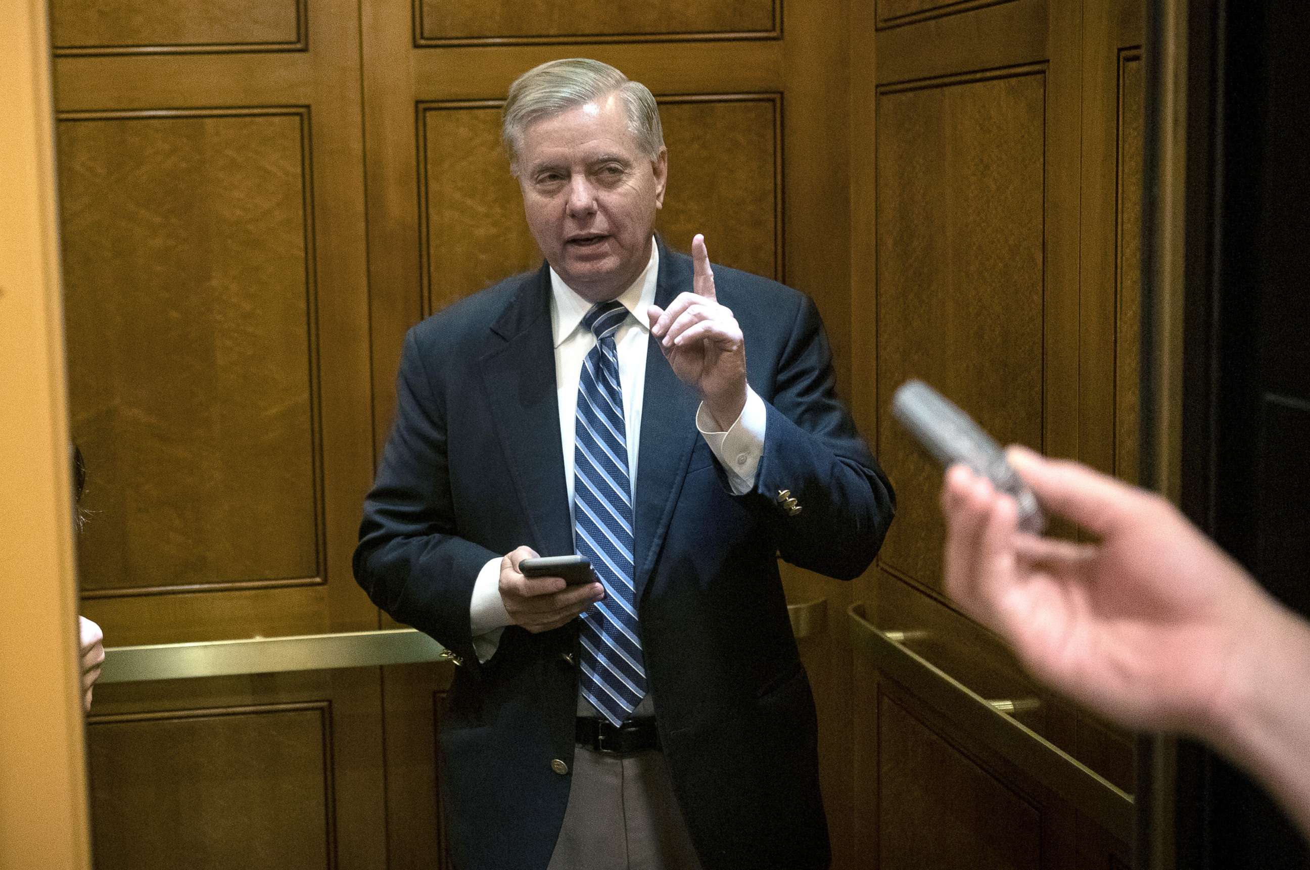 PHOTO: Senator Lindsey Graham (R-SC) talks with reporters as he walks through the Senate Subway to vote at the Capitol, Nov. 21, 2019.