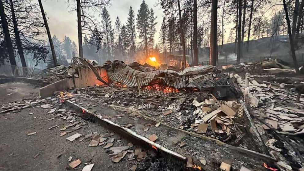 PHOTO: The remnants of a house still burn after the Gray Fire swept through the area near Medical Lake, Wash., on Aug. 18, 2023.