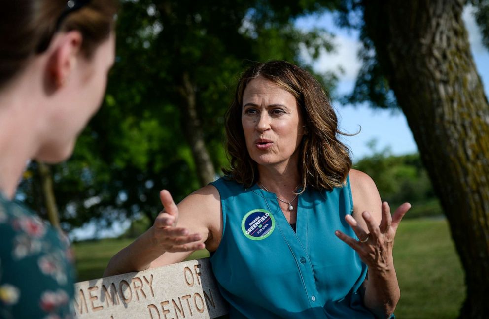 PHOTO: Democratic senate candidate Theresa Greenfield speaks with a reporter at a picnic hosted by the Adair County Democrats in Greenfield, Iowa on Sunday August 11, 2019.