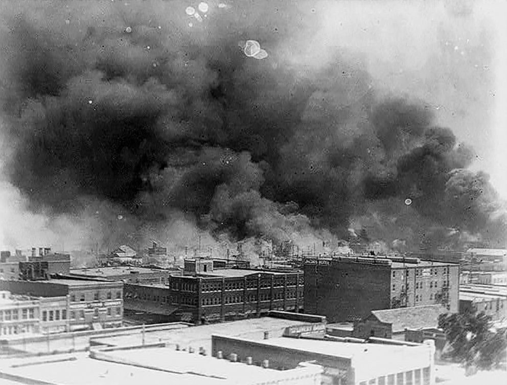 PHOTO: Smoke billows from the fires in the Greenwood neighborhood, June 1921, after the Tulsa Massacre in Tulsa, Okla.